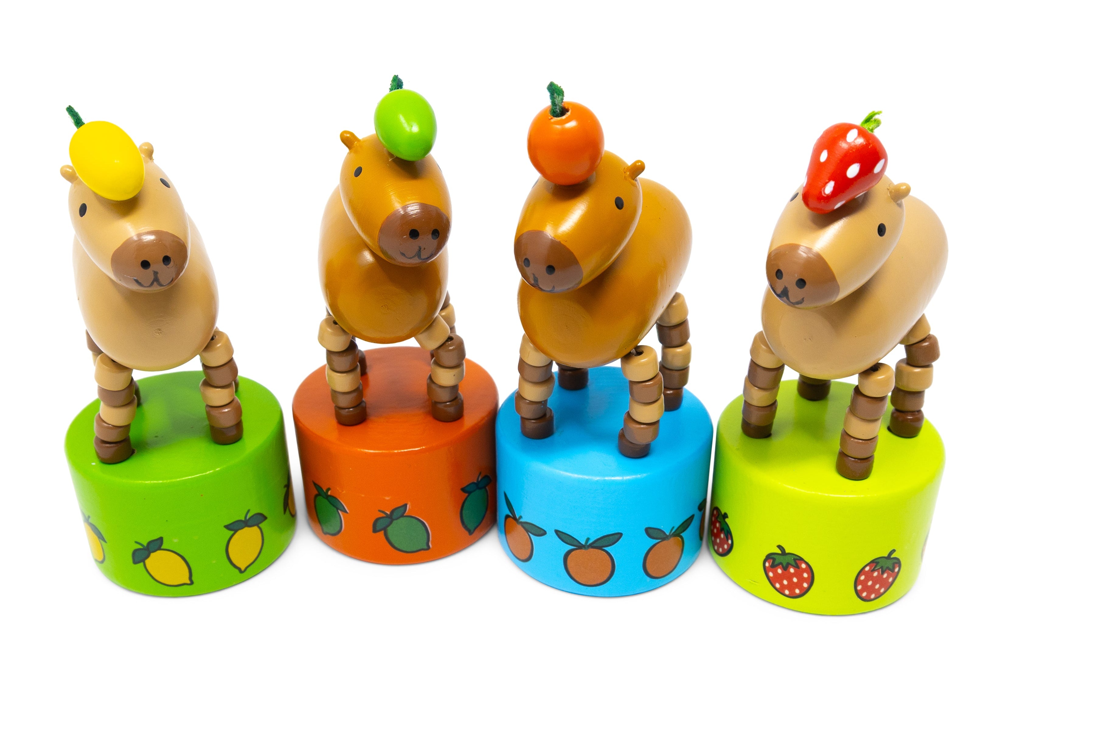 Set of wooden animal toys on colorful cylindrical stands with fruit designs on a white background