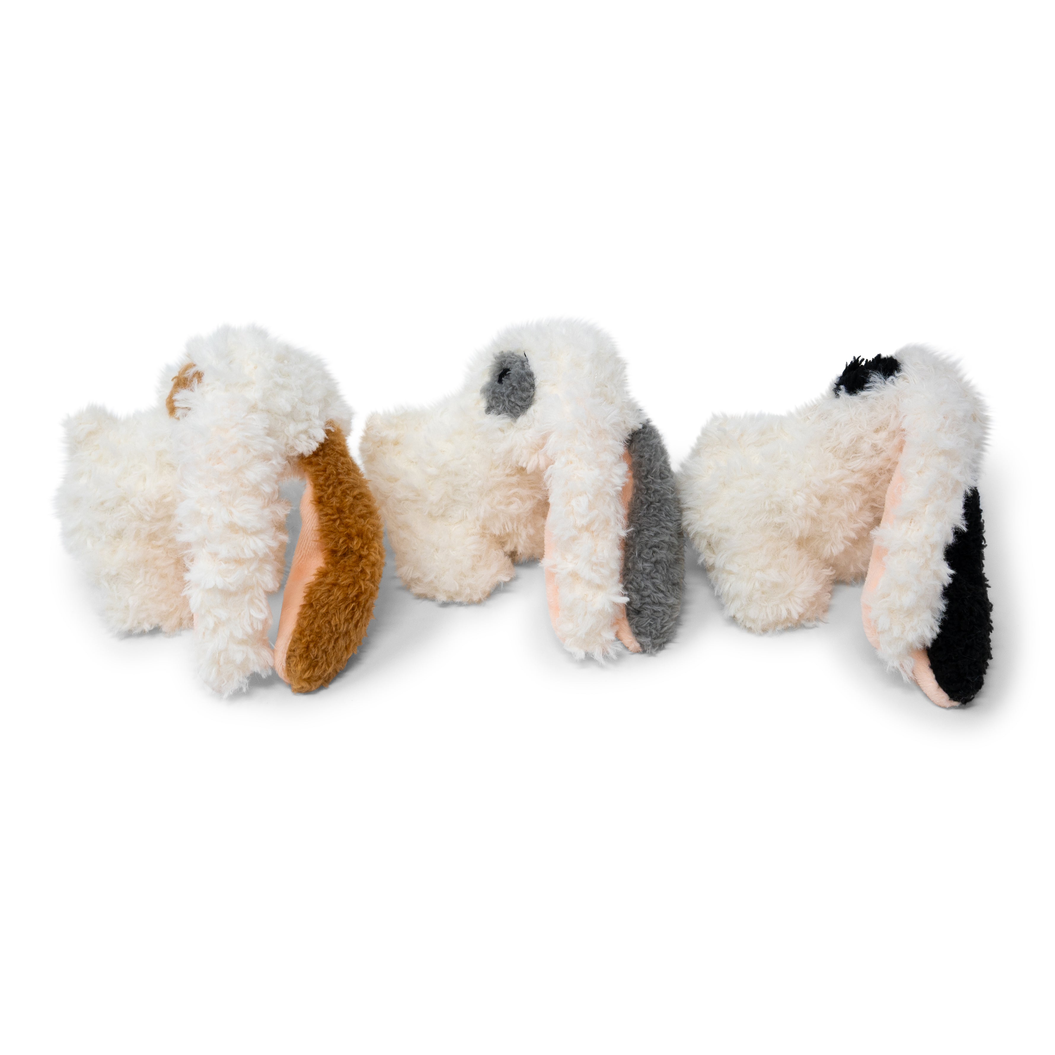 Three small plush bunnies on a white background