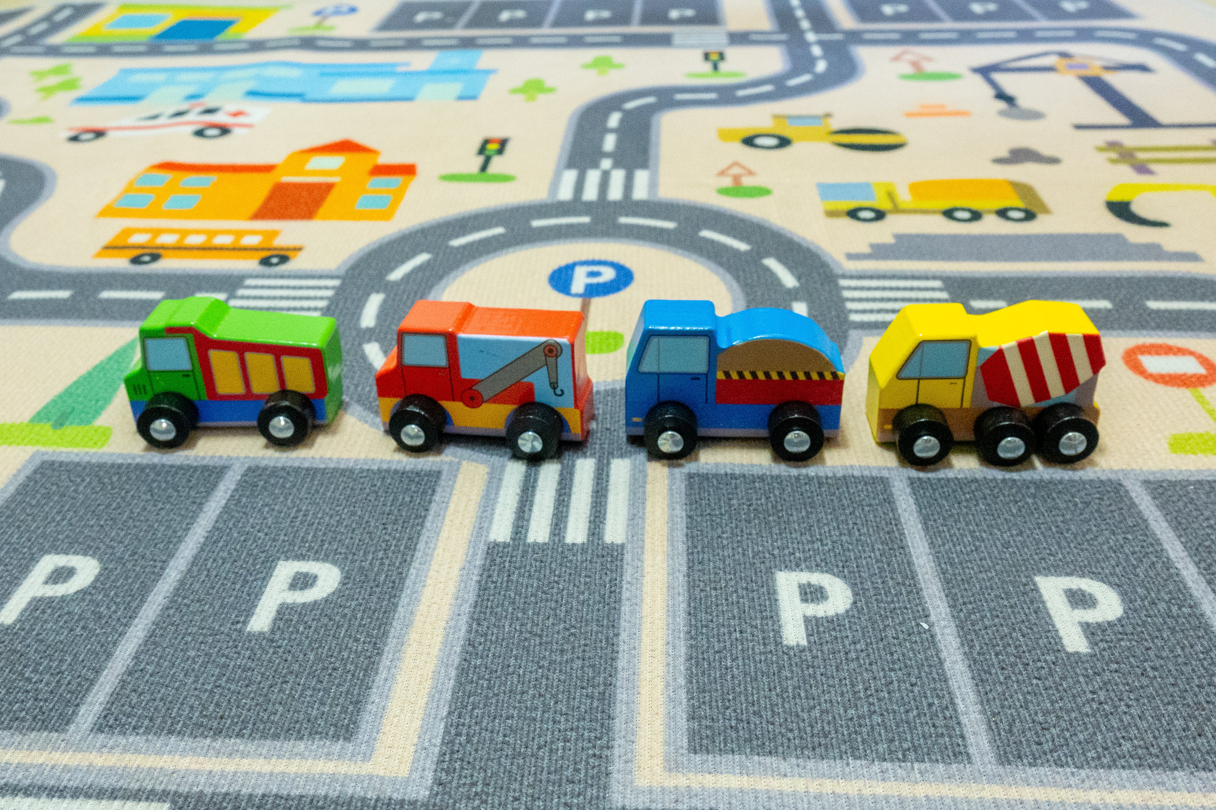 Set of colorful toy construction vehicles in front of their packaging labeled 'mighty minis' on a white background.